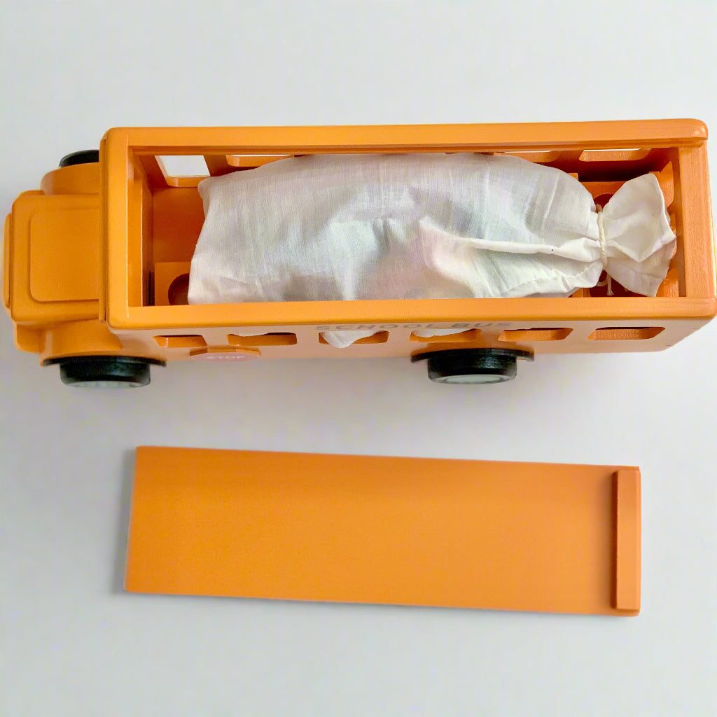 handmade wooden school bus toy and peg dolls in a pouch
