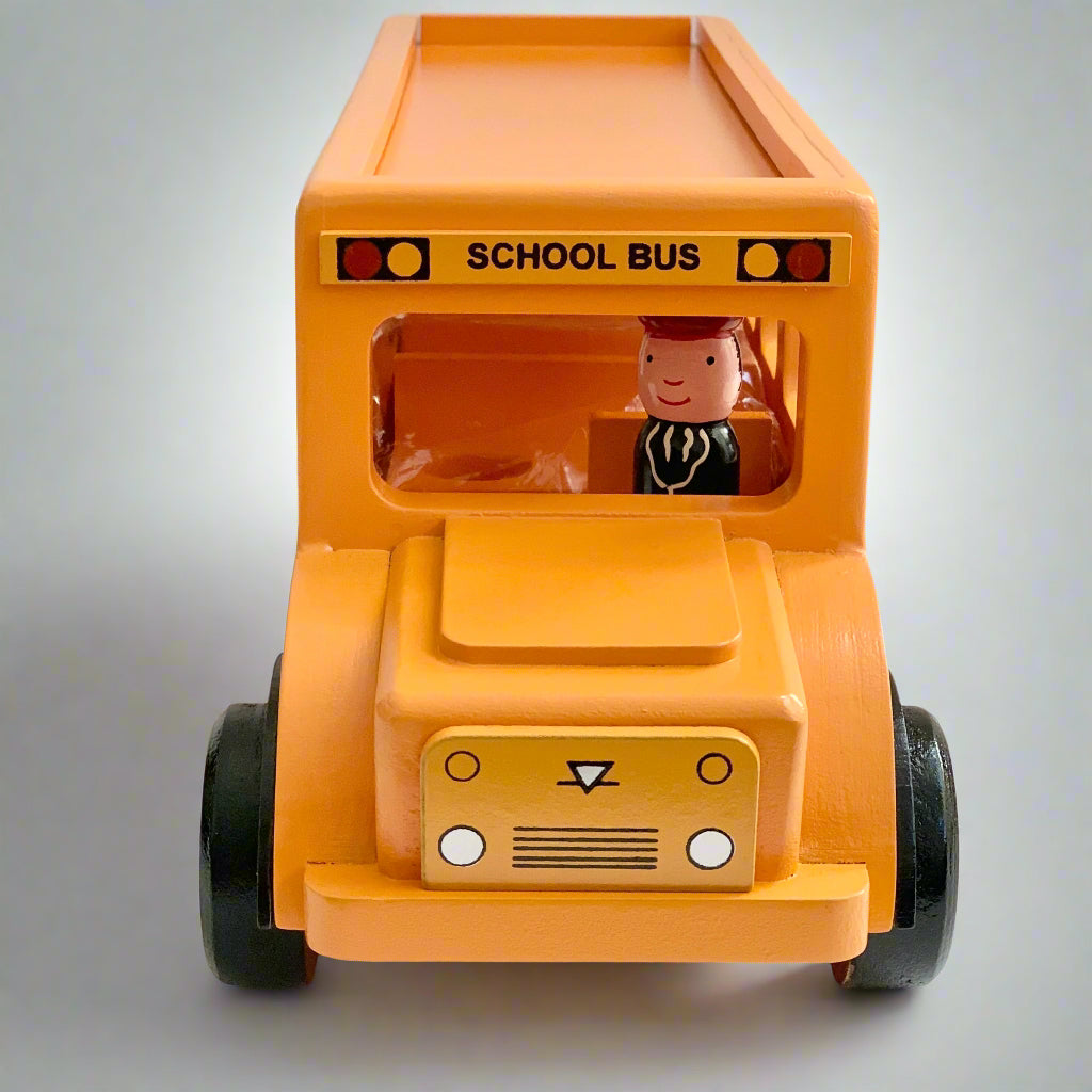 front of wooden school bus toy with peg doll driver