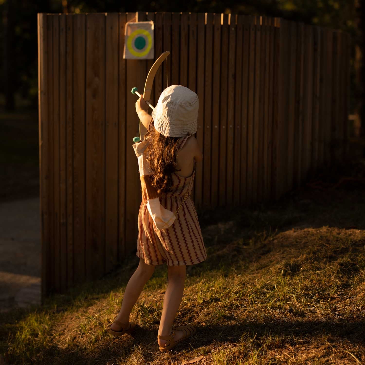 girl aiming bow and arrow