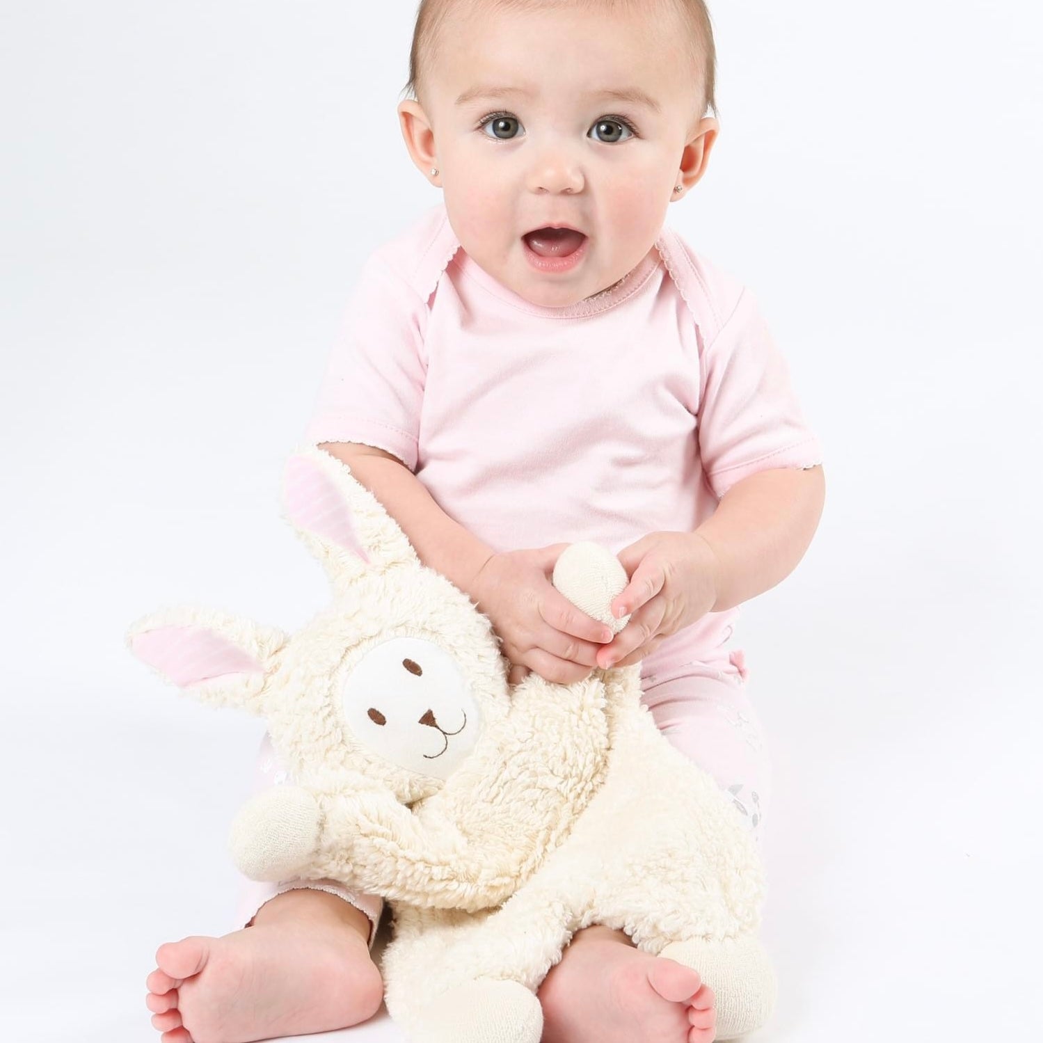Baby with organic stuffed bunny toy 