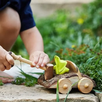 boy playing with tree blockswooden tow truck toy