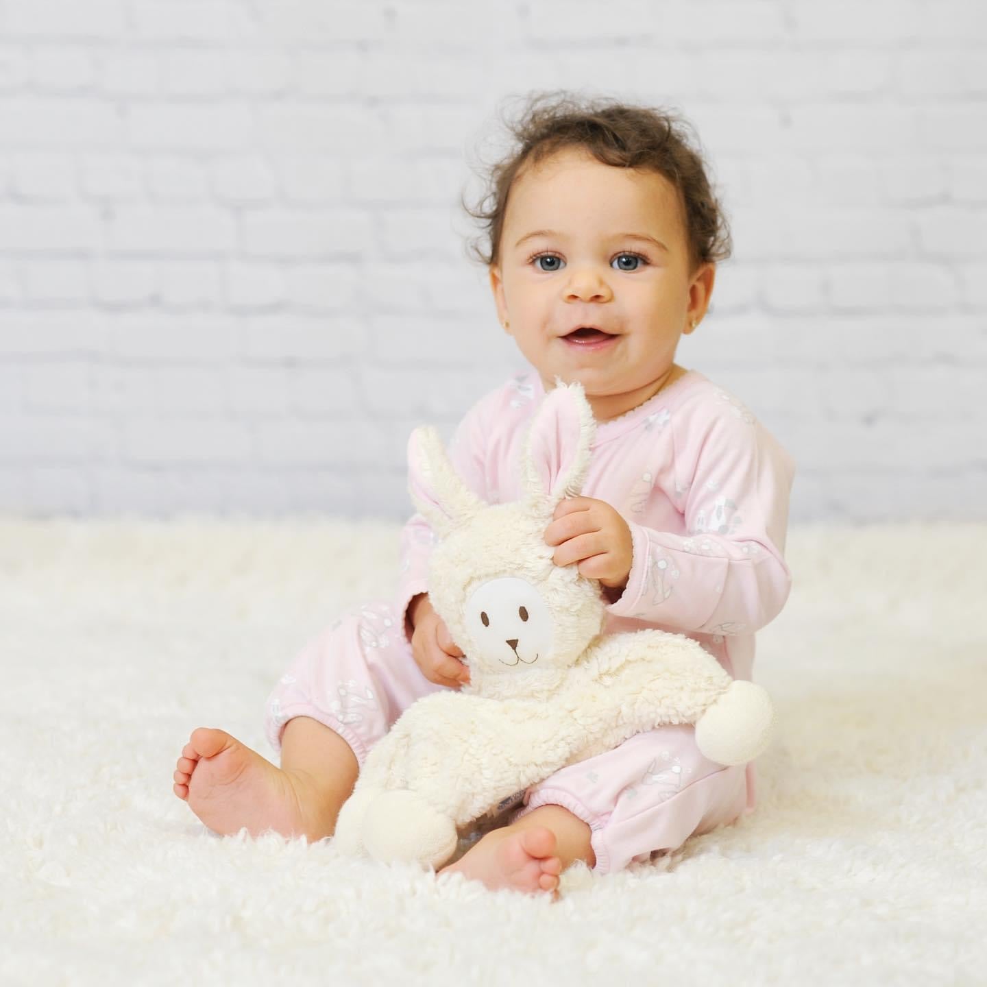 Baby holding organic bunny stuffed animal