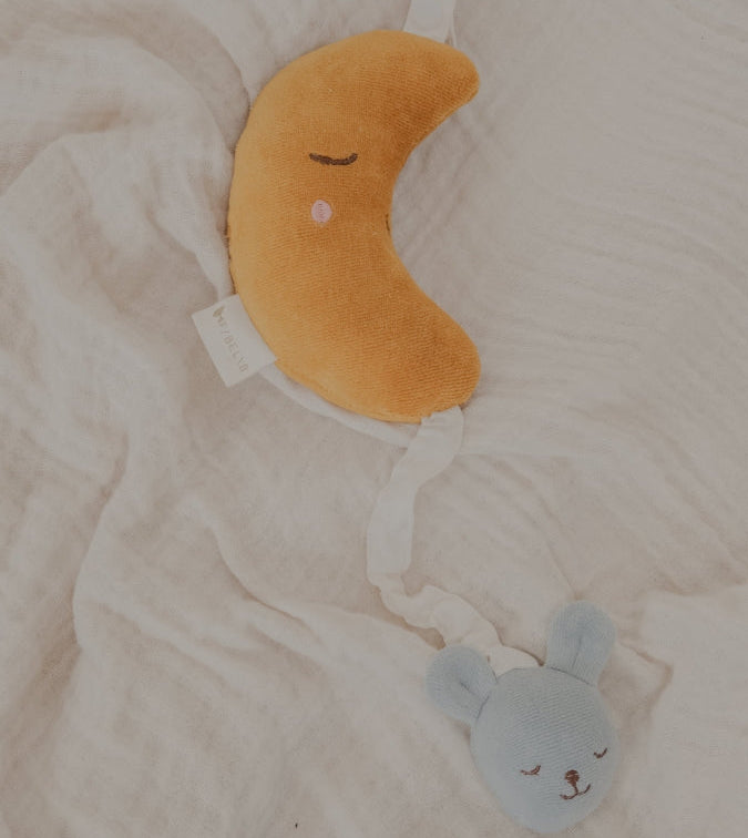 Plush toy musical moon baby mobile with a small blue bear attached to a pull string