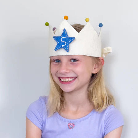 Young girl wearing a handmade felt birthday crown with number 5