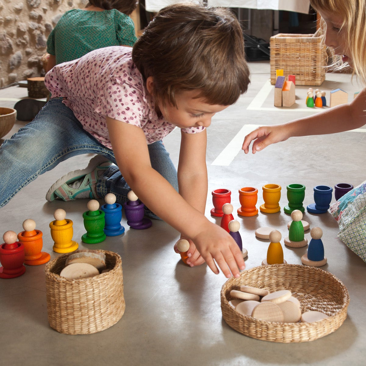 kids playing with grapat wooden rainbow nins, mates and coins toys