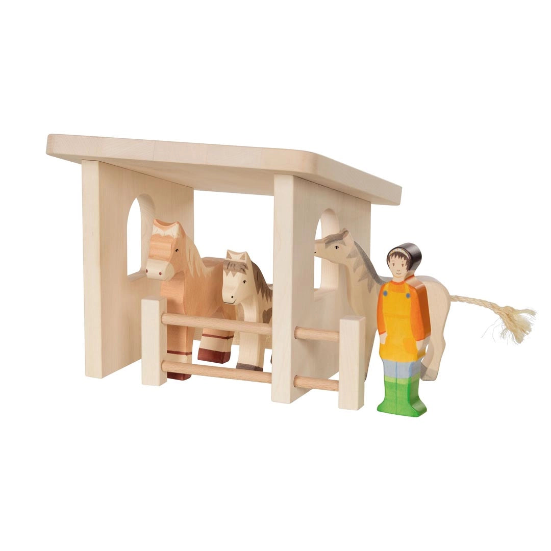 Wooden stable with two horses and a female farmer toy figure
