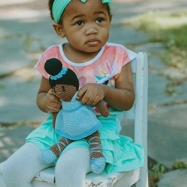 baby holding Pebble handmade black ballerina doll