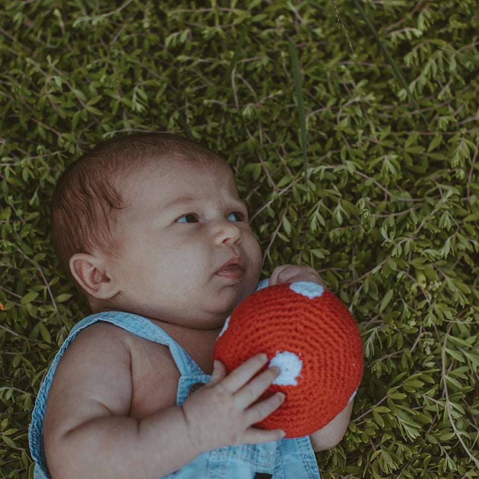 baby with organic crochet mushroom rattle