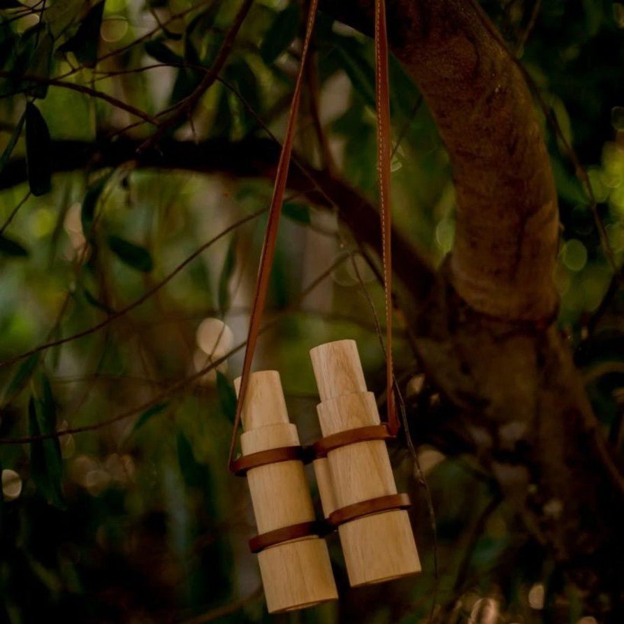 wooden toy binoculars hanging from a tree