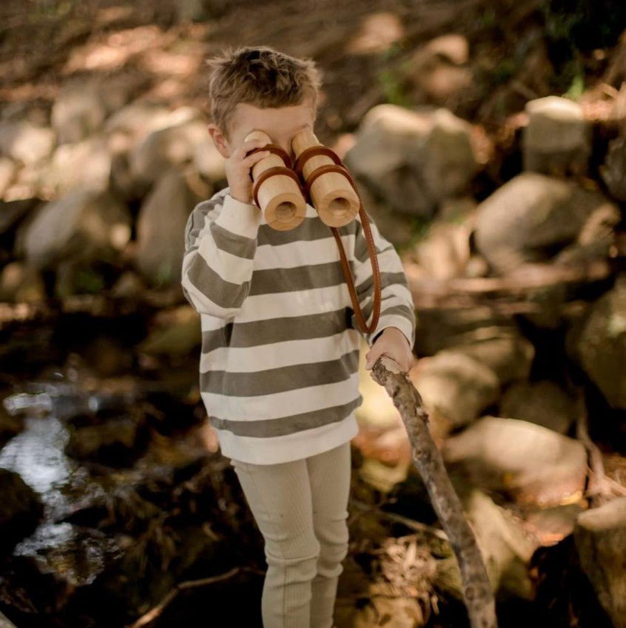 boy with wooden toy binoculars