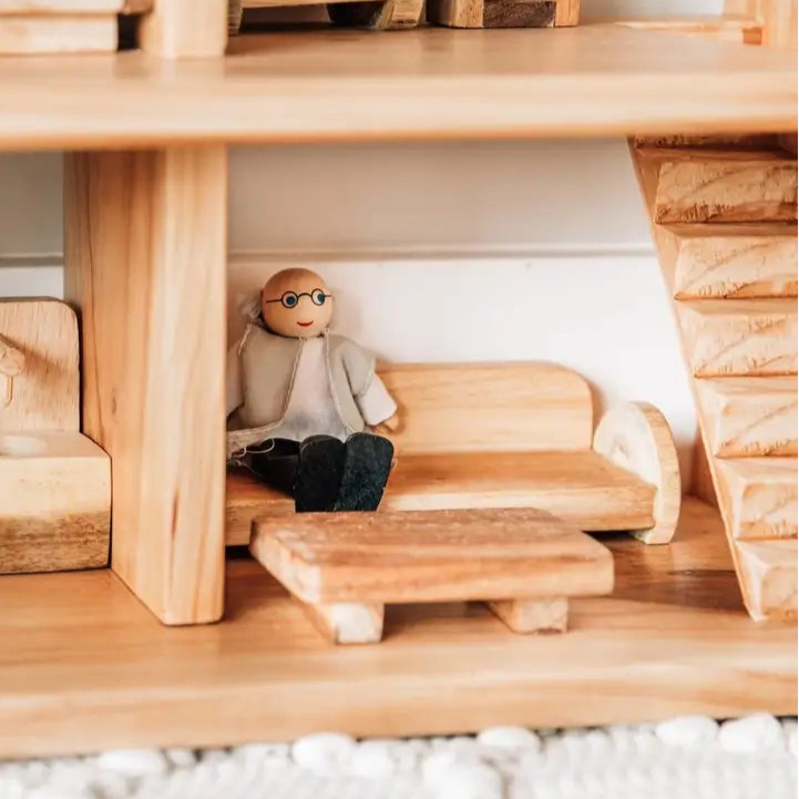 qtoys wooden doll sitting on dollshoue sofa with coffee table