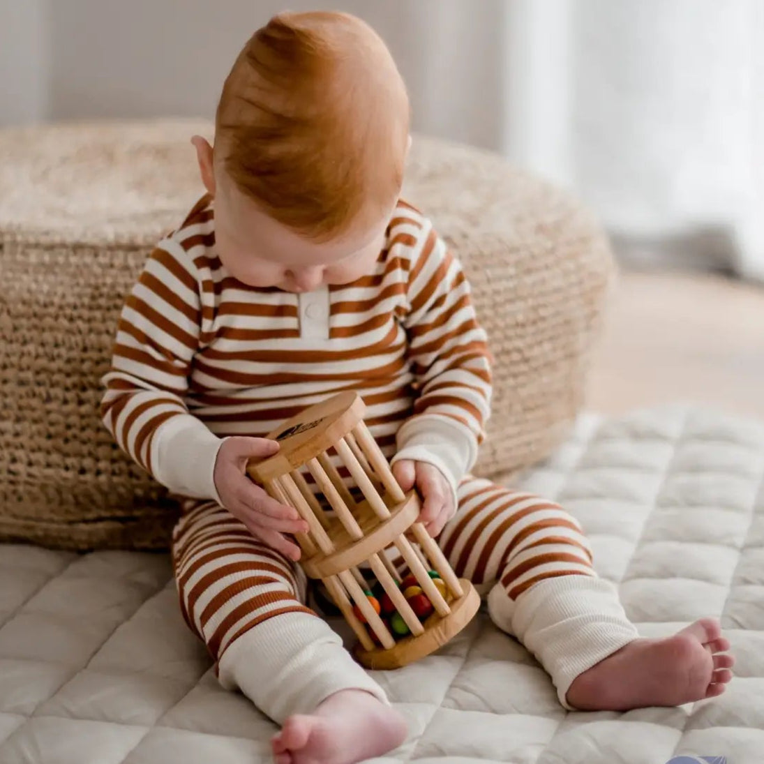 baby playing with qtoys natural wooden rainmaker toy