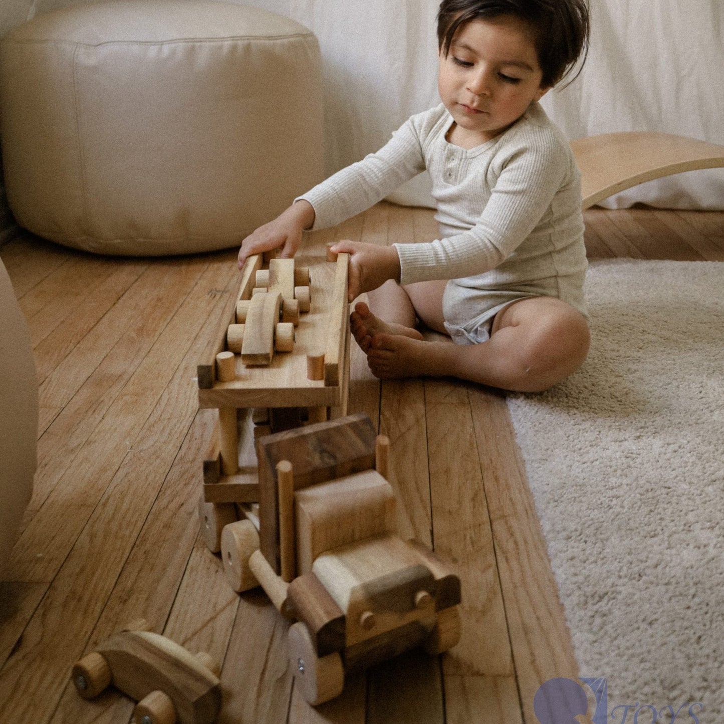 Little boy playing with Qtoys large wooden car transport truck