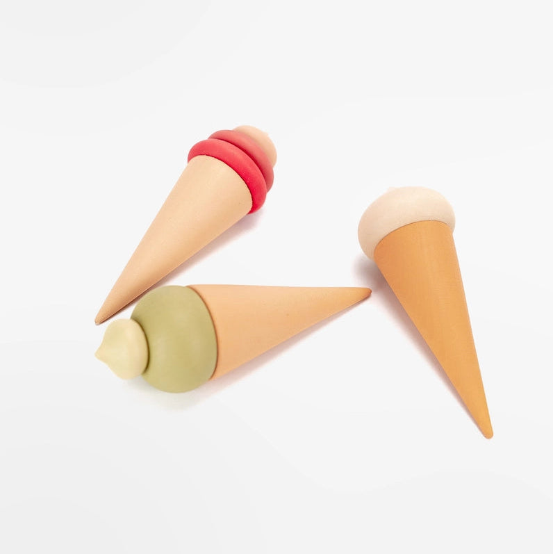 Three Sabo Concept wooden toy ice cream cones in pink, green and white.