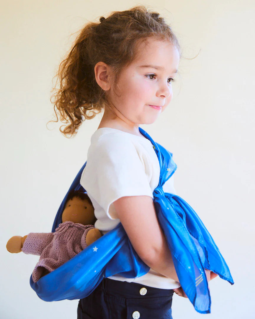 girl holding a doll with Sarah's Silk star playsilk