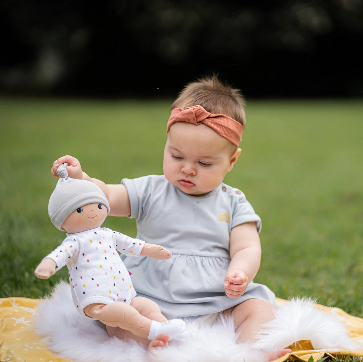 baby girl playing with tikiri toys bonikka gender neutral cotton doll