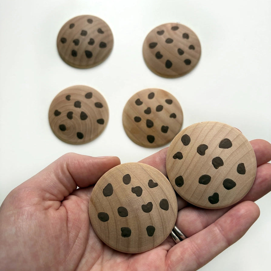 handmade wooden play food chocolate chip cookies in a hand