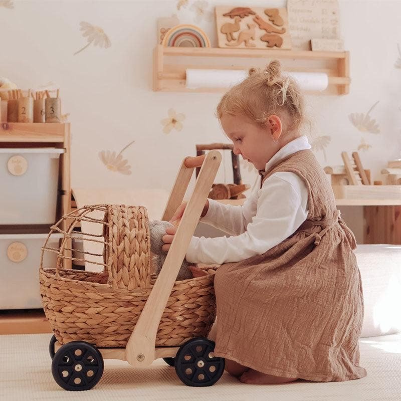 Girl with wicker doll pram baby walker