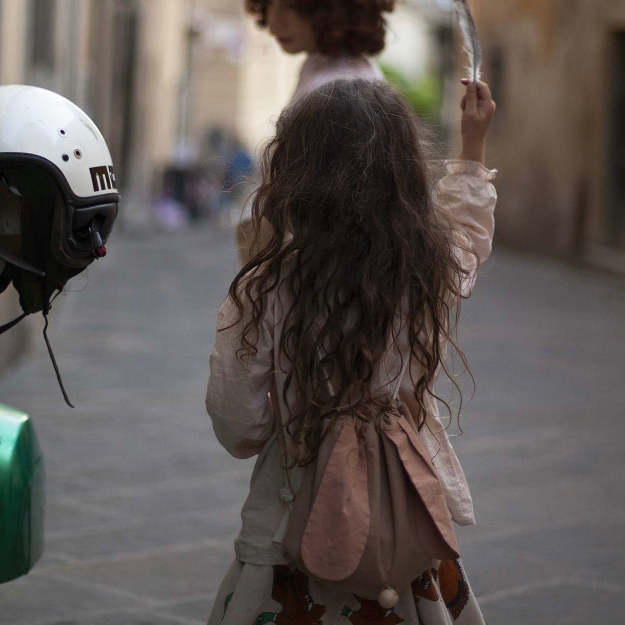 Girl in floppy ear bunny rabbit backpack