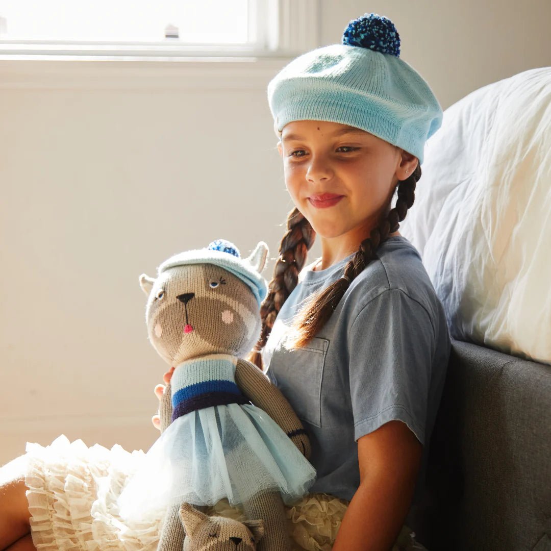 French bulldog stuffed animal and girl in matching beret