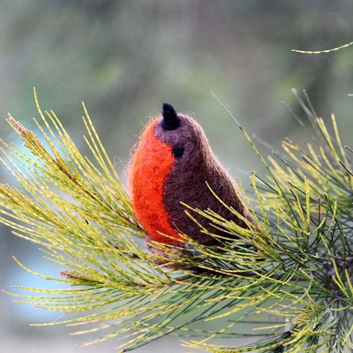 Felt toy Robin stuffed animal on a branch