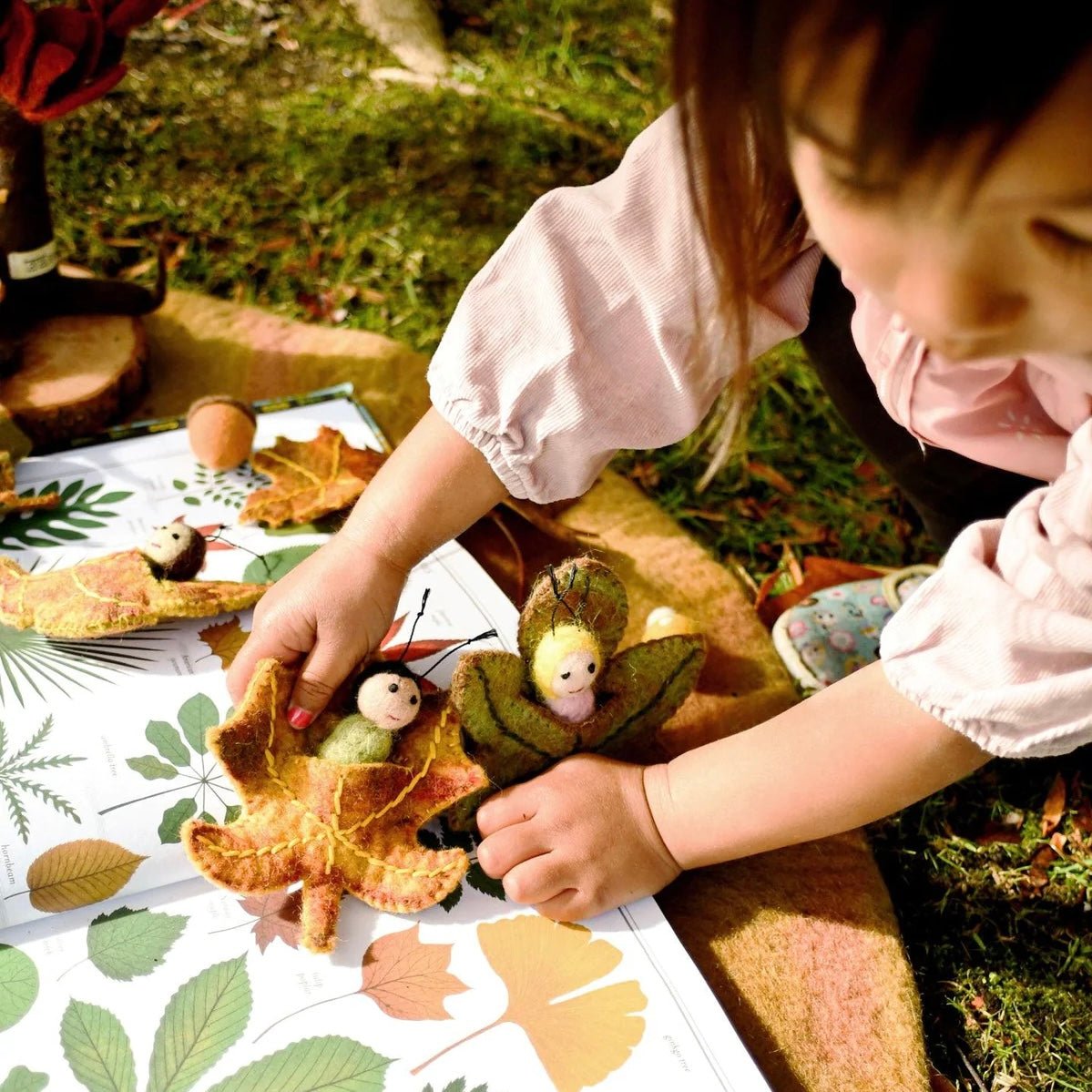 Girl playing with leaf fairy babies