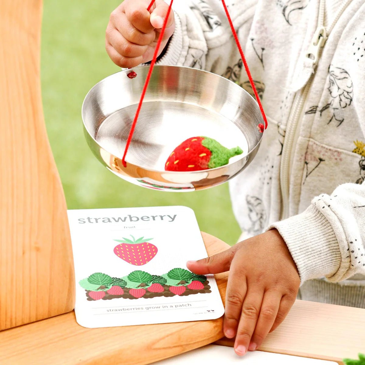 Child with felt strawberry play food
