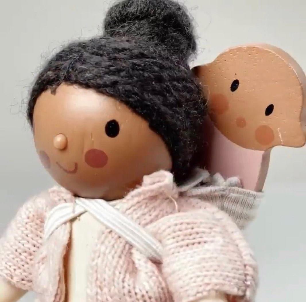 black dollhouse doll close