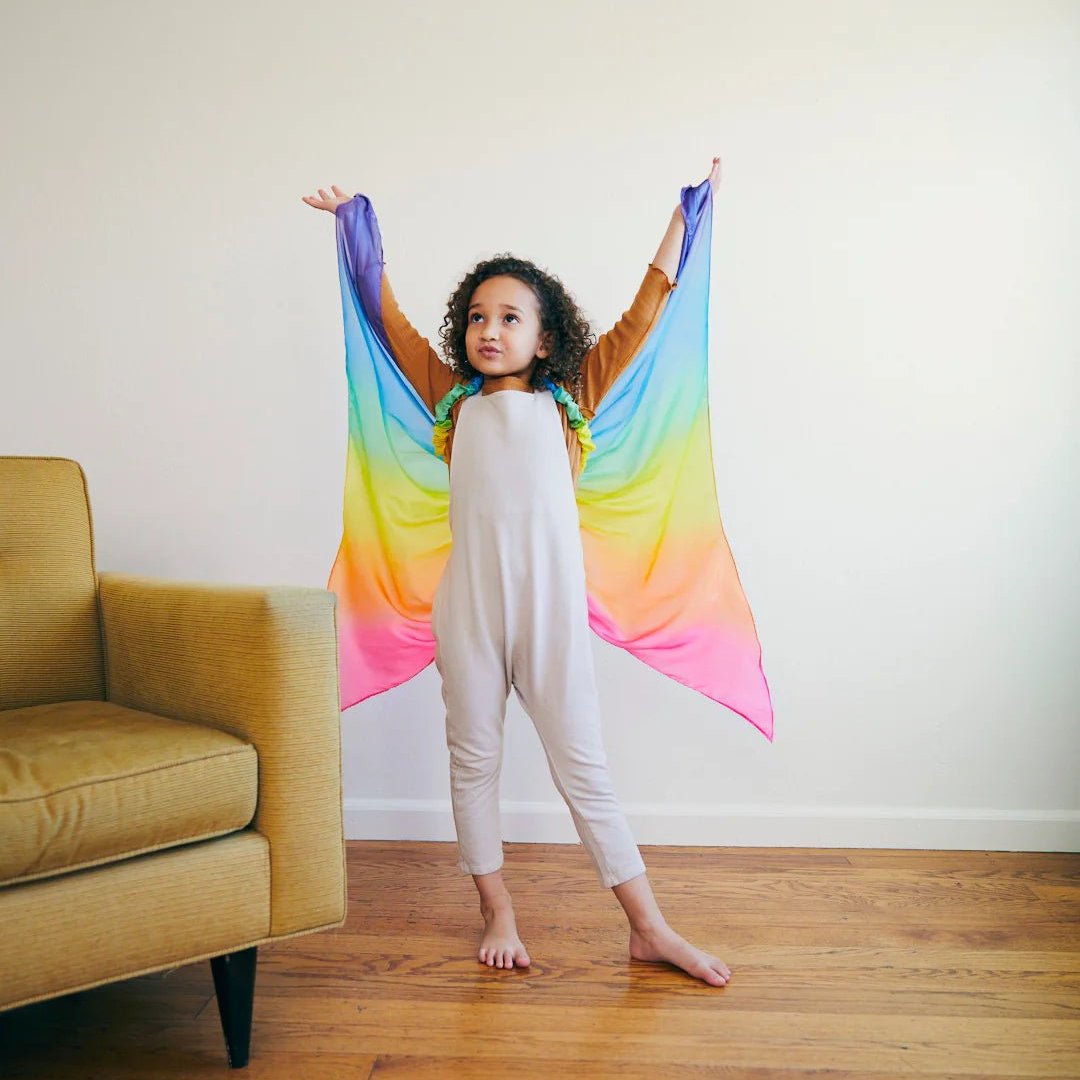 girl wearing sarah's silks rainbow fairy wings