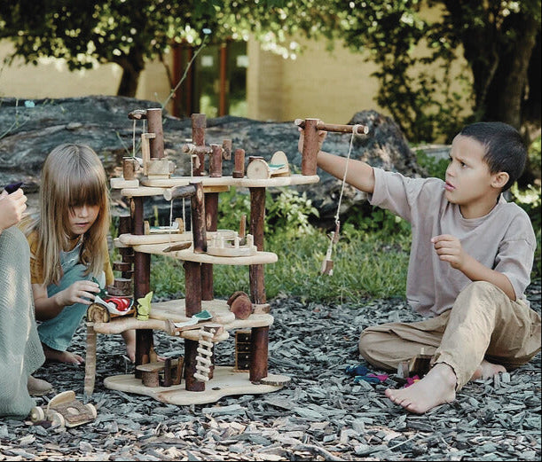 boy and girl playing with Waldorf tree blocks treehouse toys