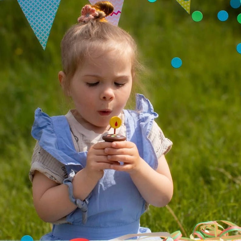 girl holding erzi wooden cupcake