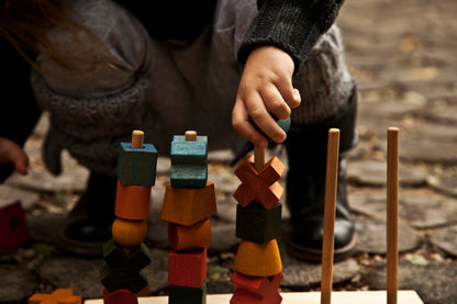 child playing with Montessori wooden sorting and stacking toy