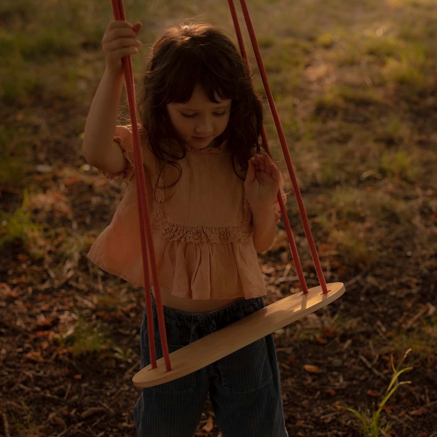 girl with portable wooden swing