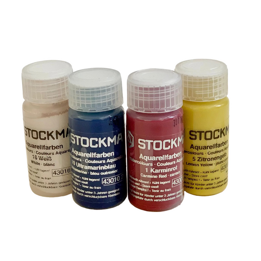 Four bottles of 20 ml Stockmar watercolor paint in carmine red, ultramarine blue, lemon yellow, and white