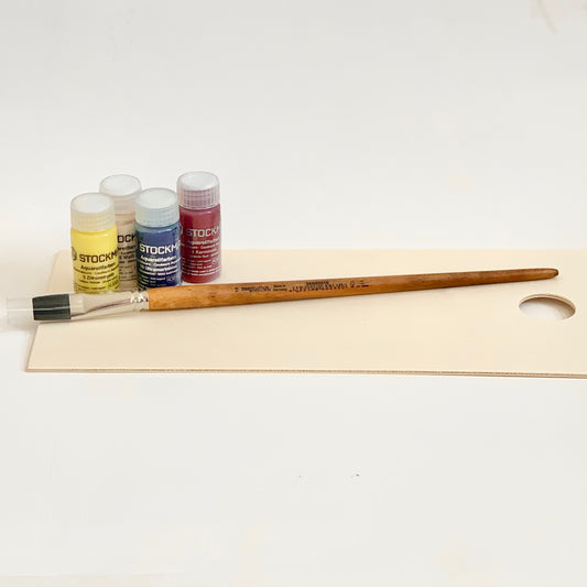 Stockmar watercolor paint with a flat tip wooden paint brush.