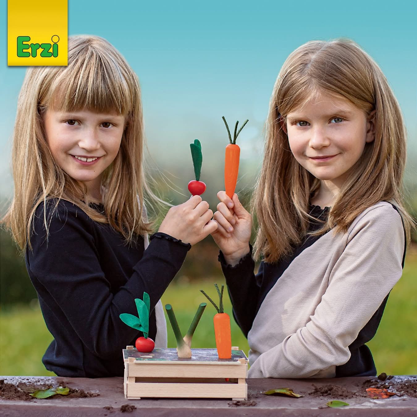 Girls holding erzi wooden carrot and radish