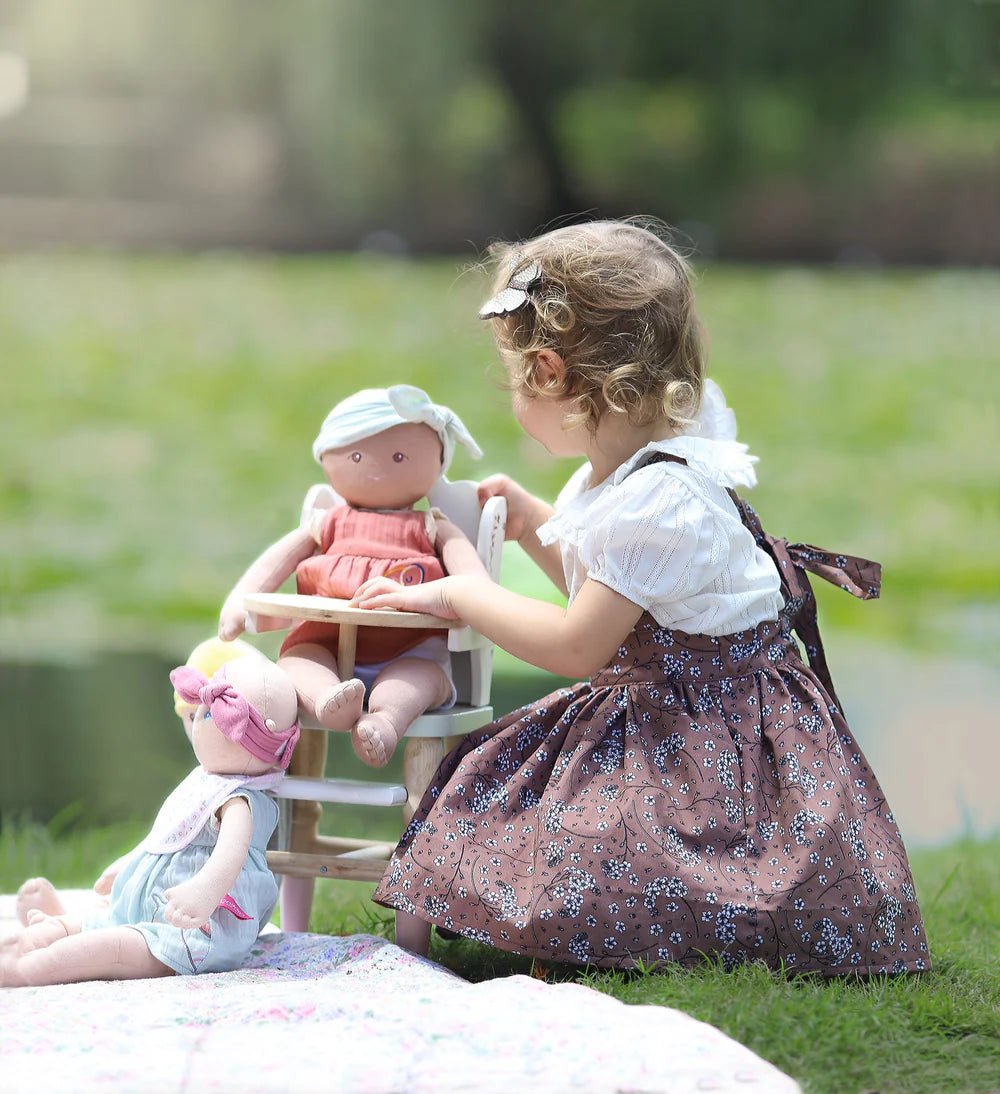 girl with organic baby doll and highchair