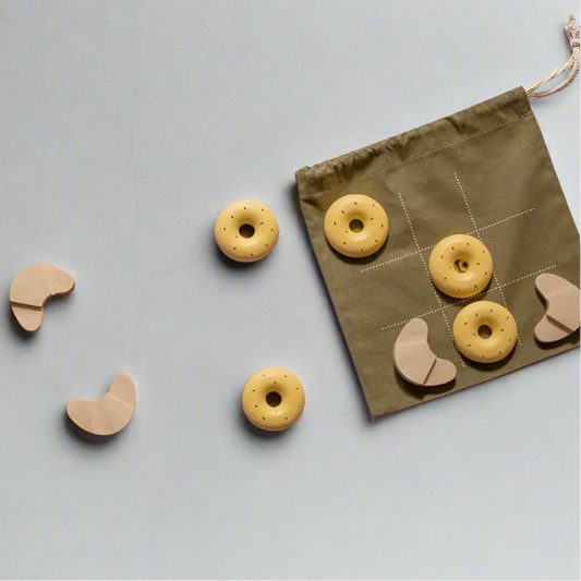 babai travel tic tac toe game with wooden donuts and croissant pieces