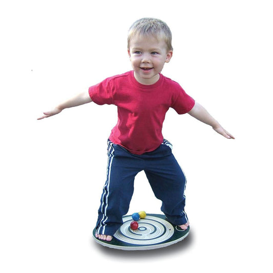Child standing on a wooden labyrinth balance board with colorful balls