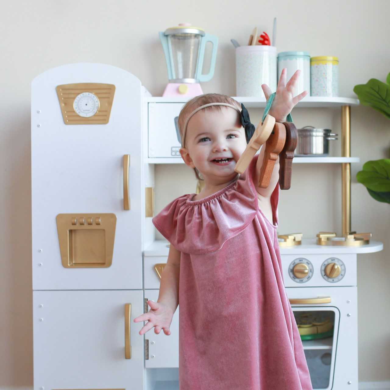 toddler playing with wooden toy keys