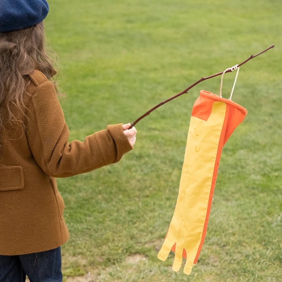 girl holding cat wind catcher toy on a stick