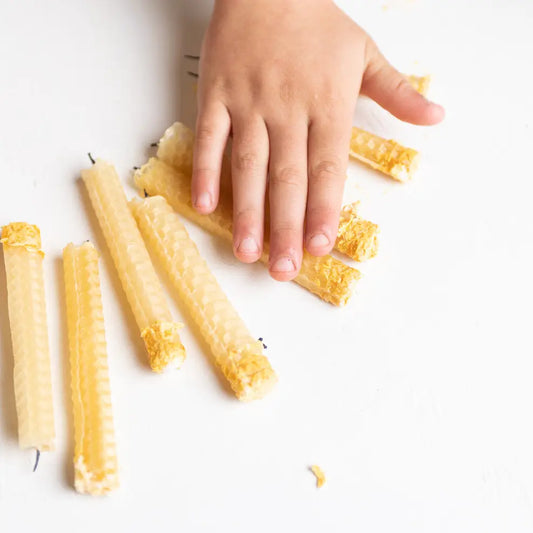 child's hand rolling eco kids beeswax candles