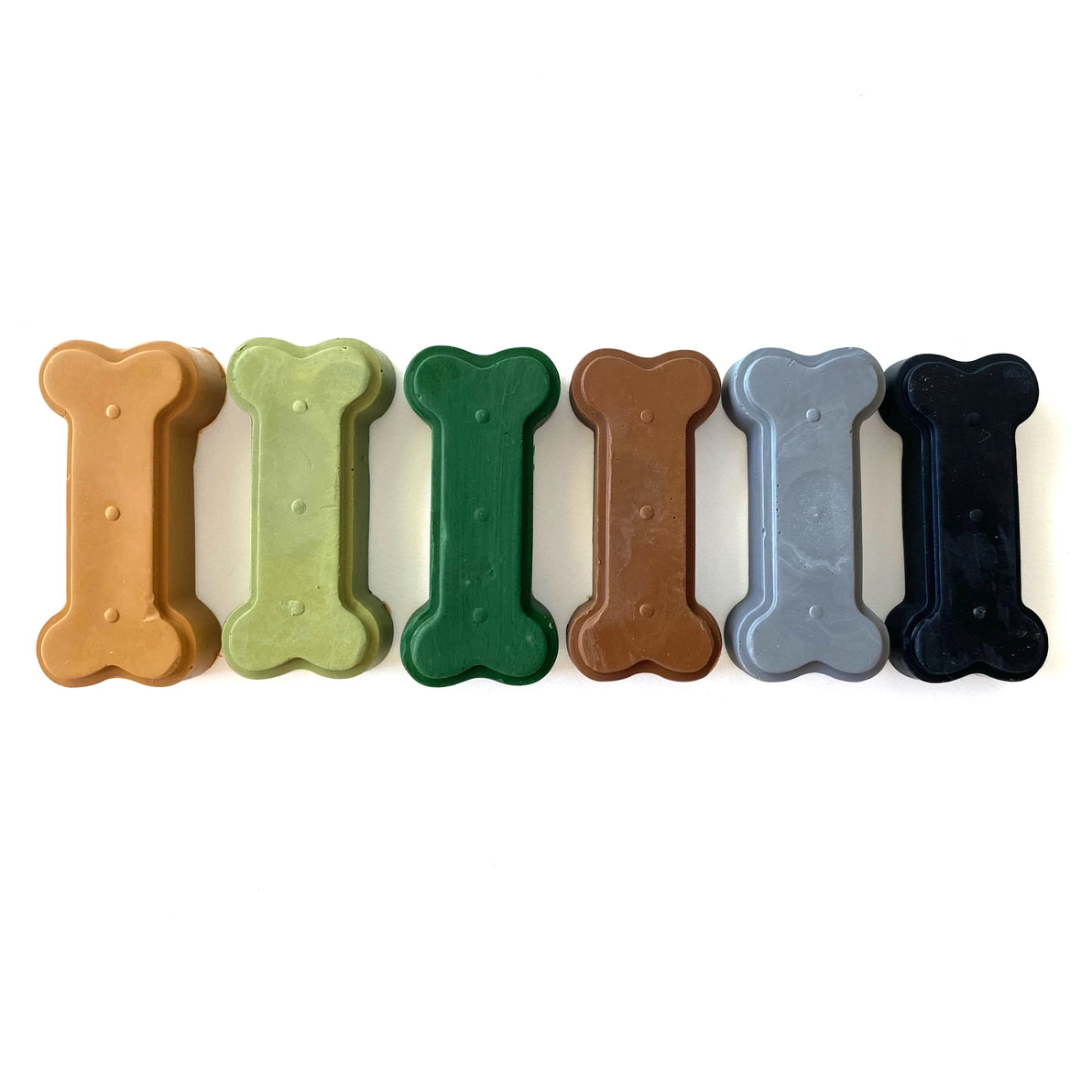 Set of six dinosaur bone-shaped  beeswax crayons in earthtones