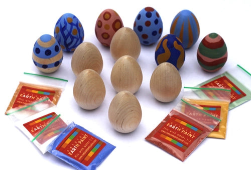 Wooden eggs with colorful patterns and packets of earth paint 