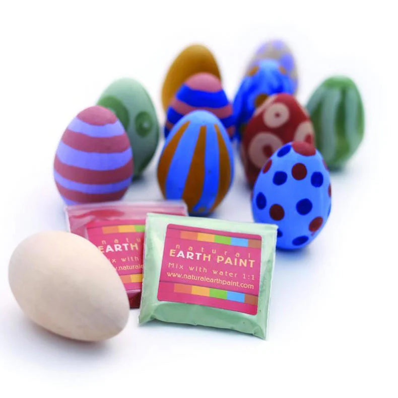 Colorful painted wooden eggs and packets of natural earth paint 