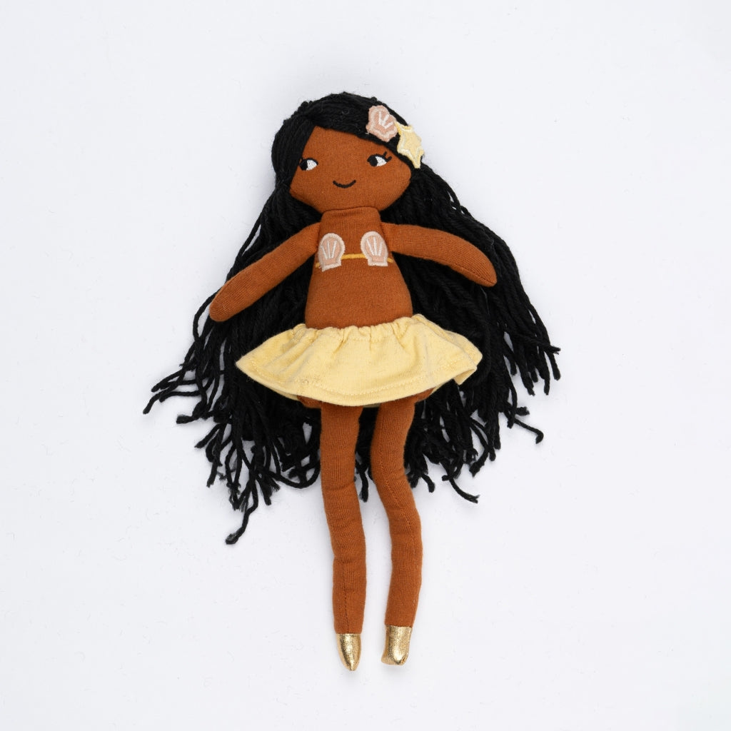 Plush doll with long black hair, brown skin, and a yellow skirt