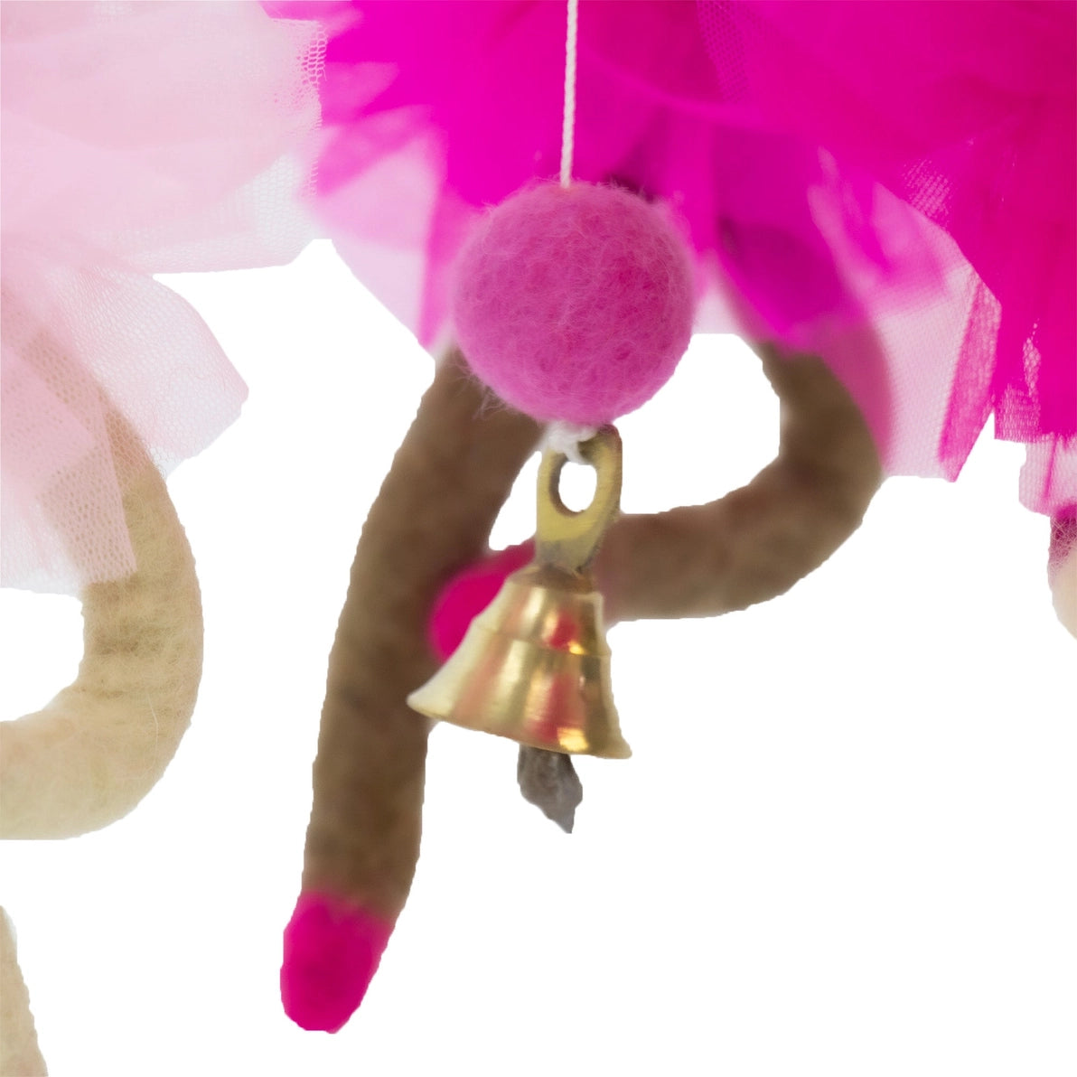 Close up of brown legs and a bell from a felt ballerina baby mobile