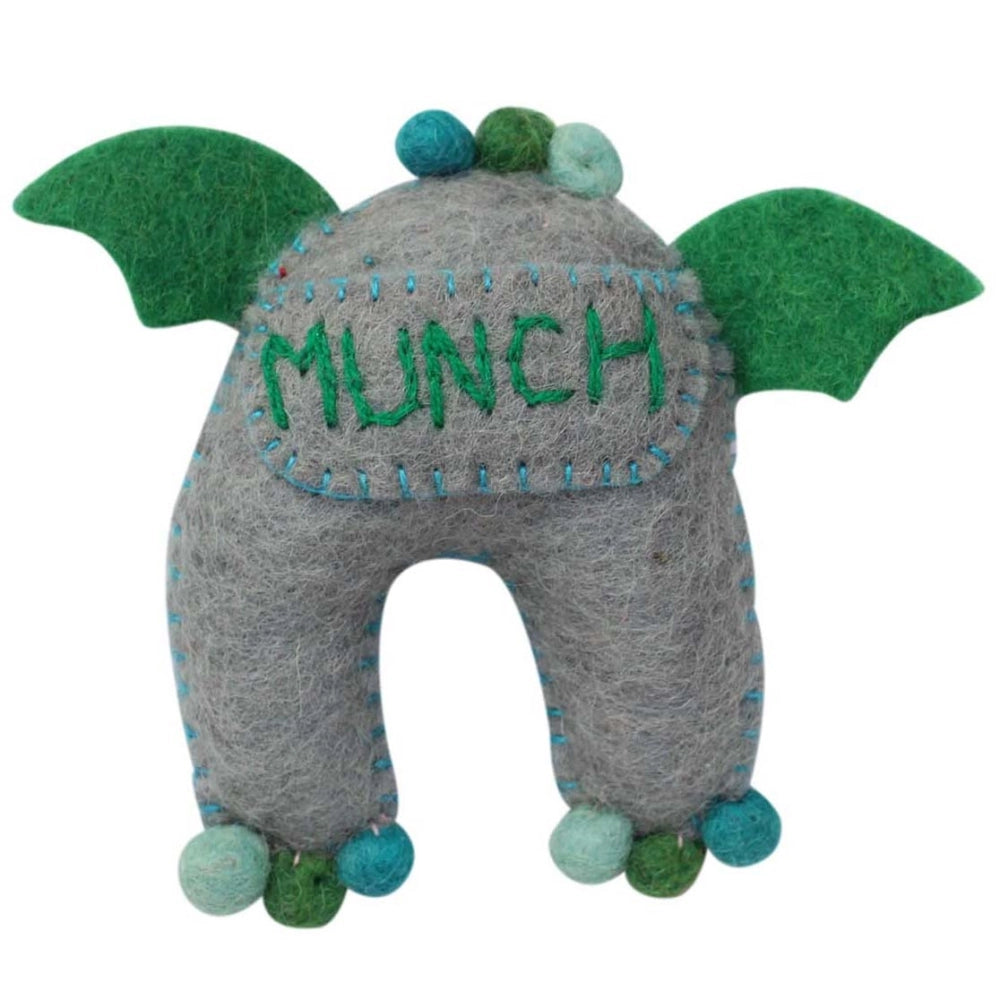 Felt plush monster tooth fairy pillow toy with green wings and 'MUNCH' embroidered on a pocket