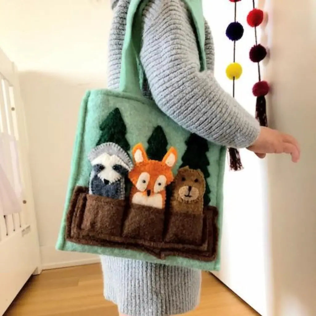 girl wearing fair trade felt forest animals finger puppet bag fox, raccoon, bear