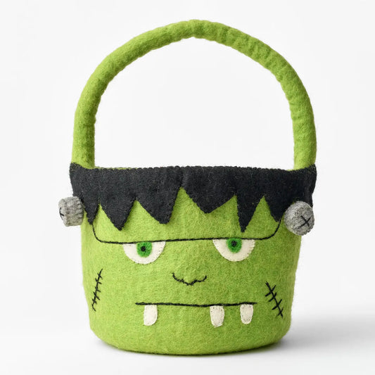 A felt Frankenstein monster Halloween candy bucket featuring a black stitched hair, embroidered eyes, mouth, and teeth.
